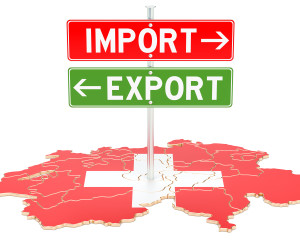 Panneaux "Import" et "Export" au-dessus d'une carte de la Suisse